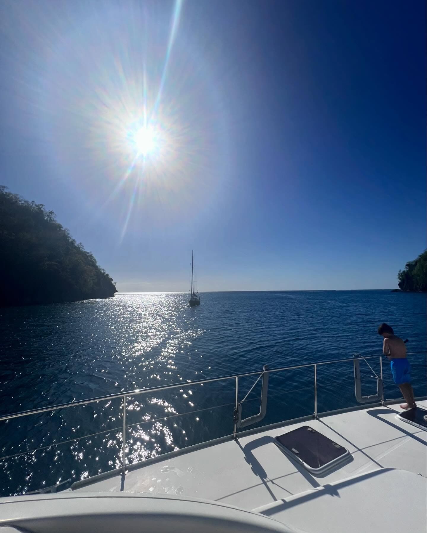 Guests relaxing on a luxury catamaran deck at golden hour