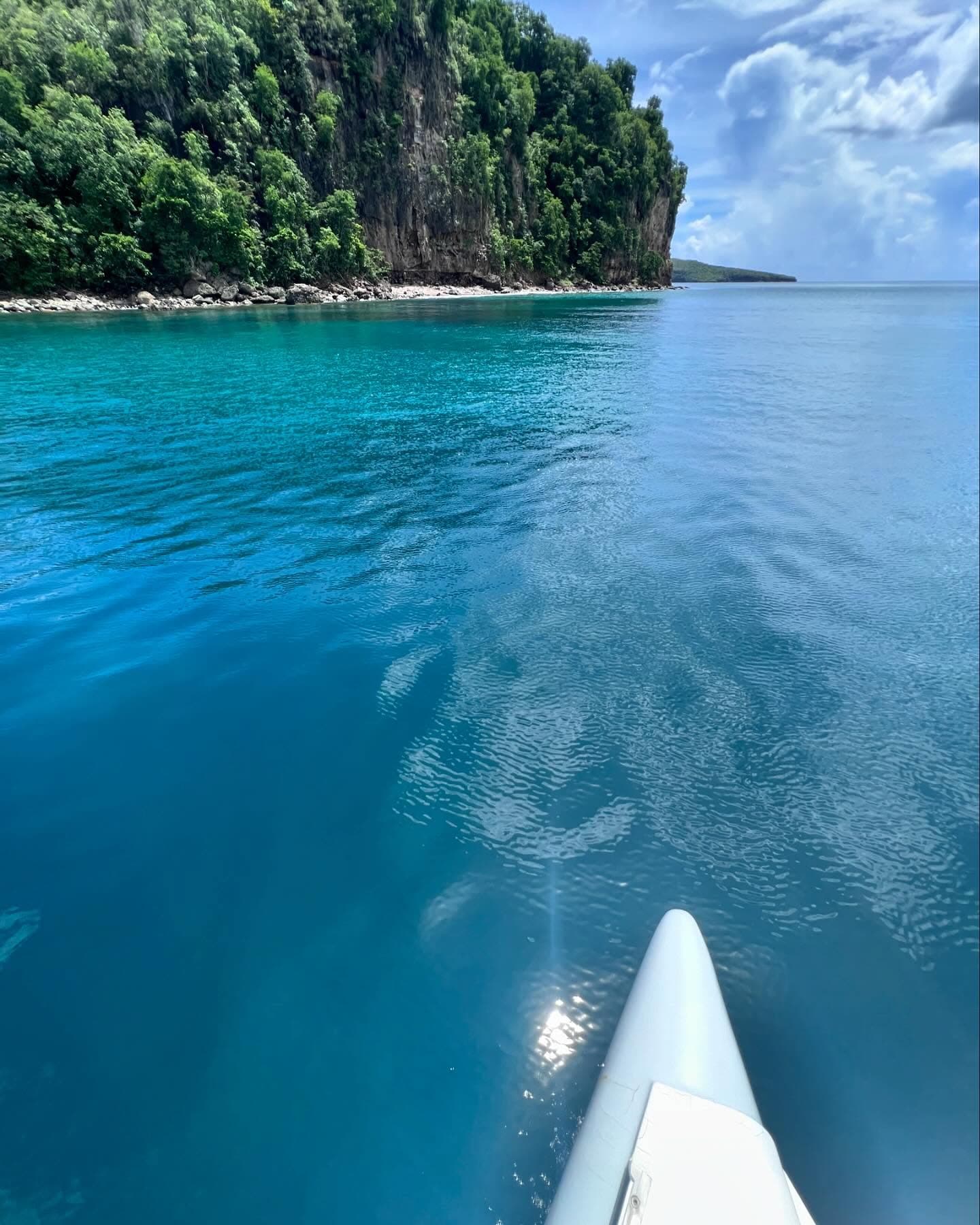 Bow of 50ft Luxury Power Cat approaching a lush Saint Lucia coastline