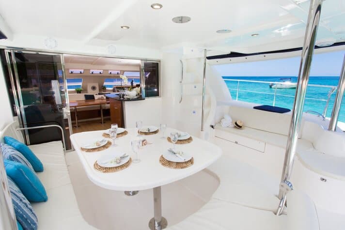 50ft Luxury Power Cat luxury catamaran anchored in turquoise Saint Lucia water near a lush hillside